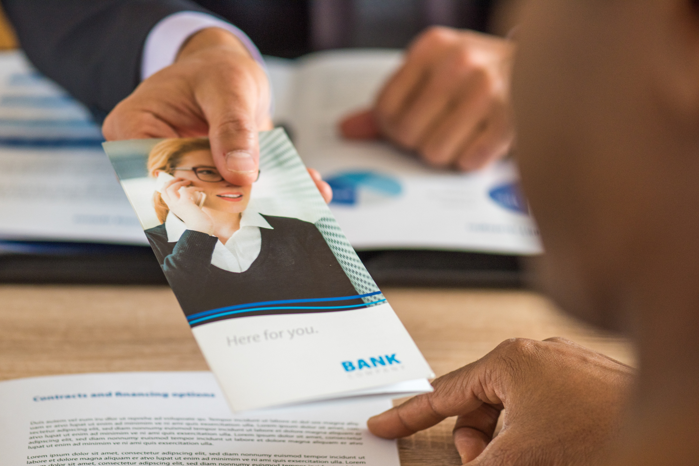 Human hand holding brochure